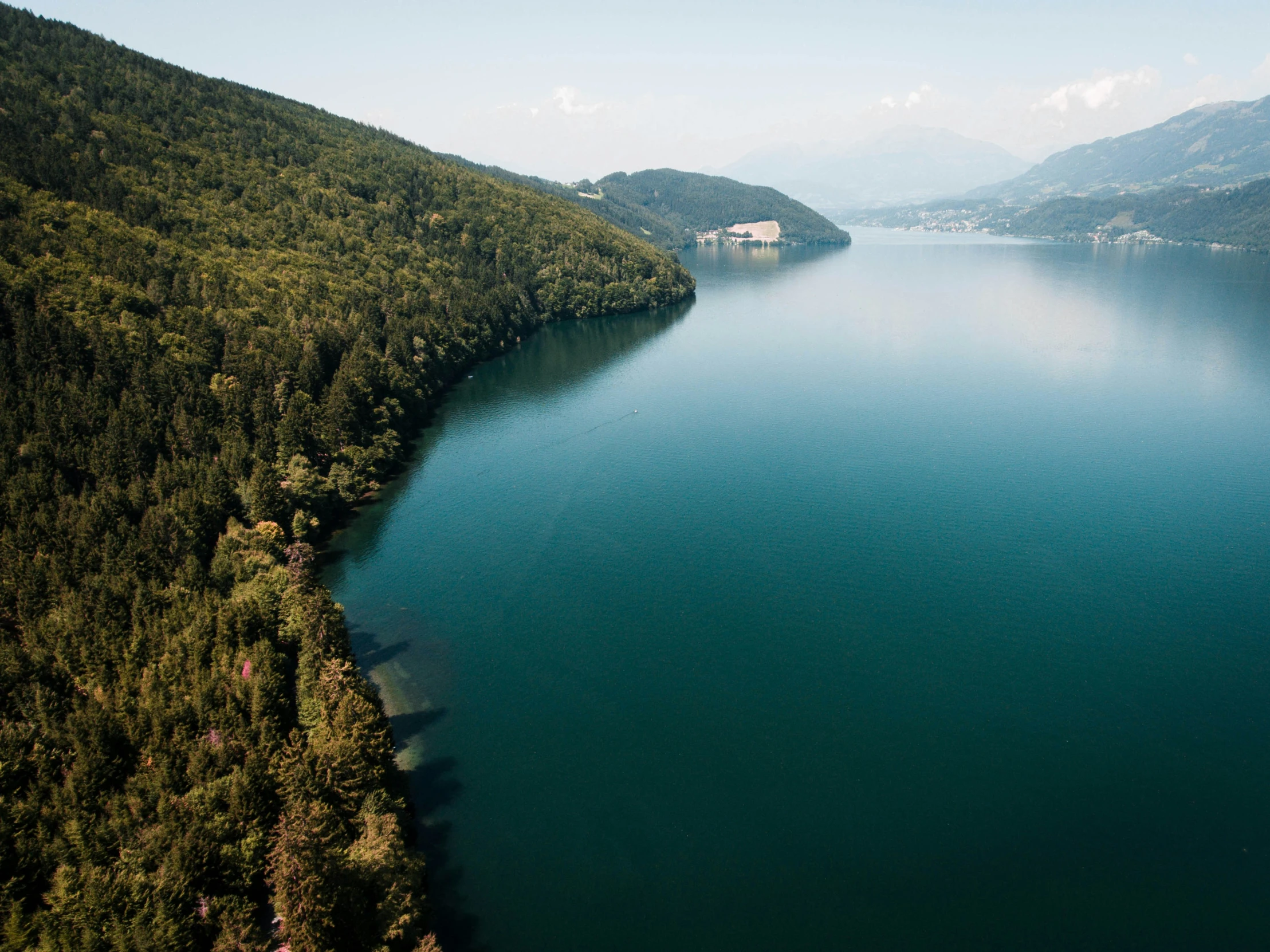 a very pretty lake surrounded by green mountains