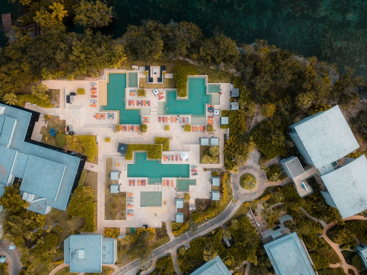 an overhead view of a resort with lots of swimming pools