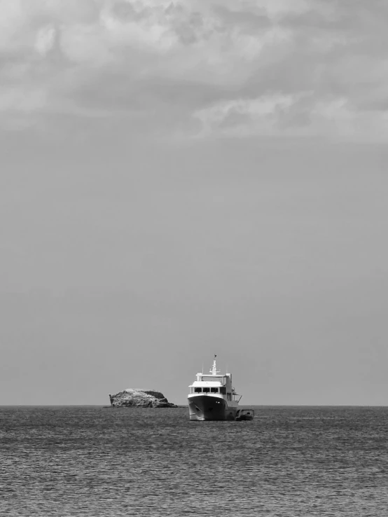 a large boat sits at a pier in the ocean