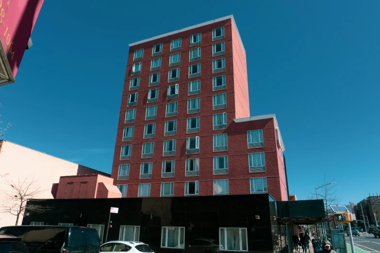 a large tall brick building next to a tall building
