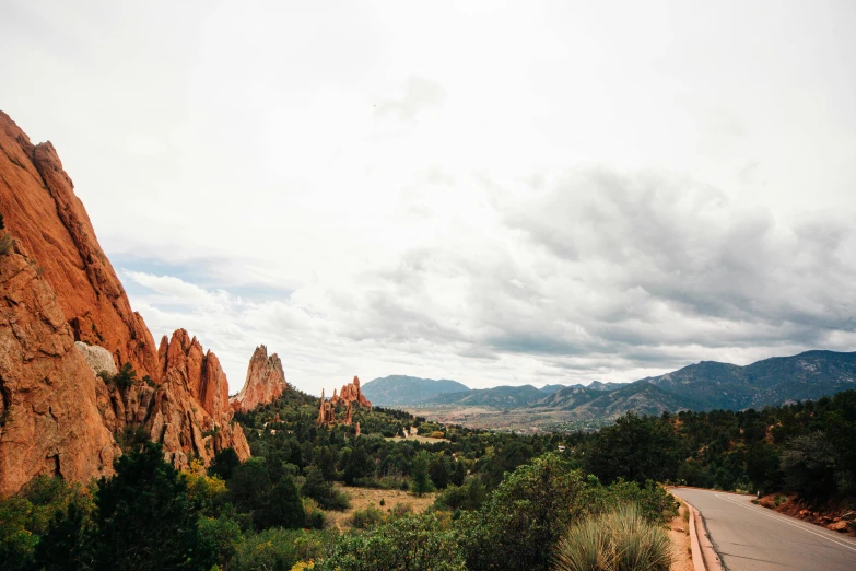 the mountains have rock formations along with a road