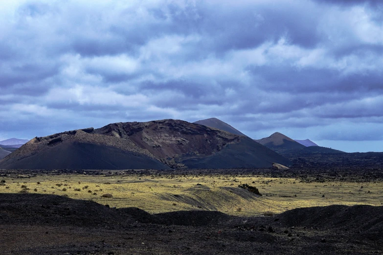 a view of a vast mountain range with trees in the background