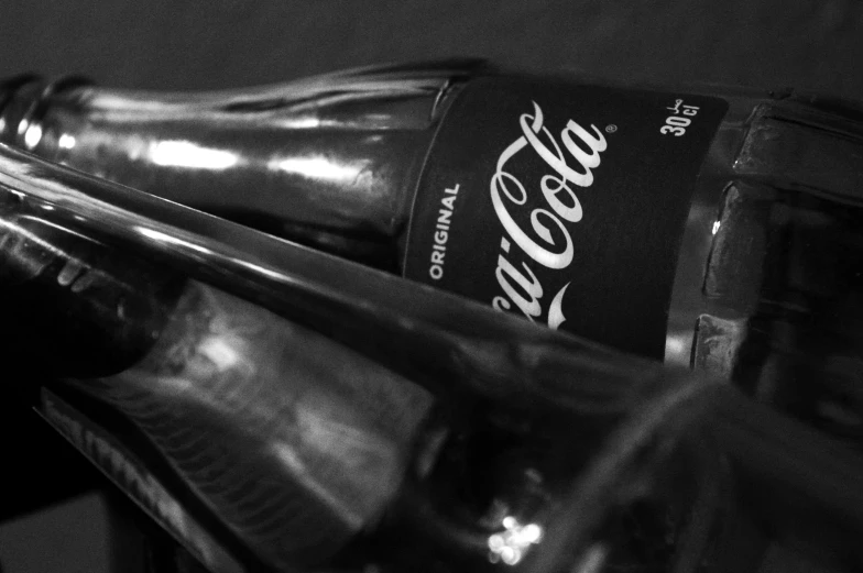 a black and white po of a bottle of coca - cola
