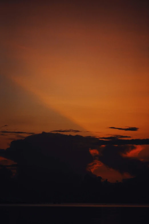 a airplane flying at dusk above the clouds