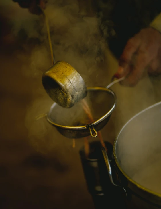 a close up of a person stirring soing in a pot