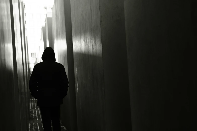 a man is walking through the hallway in a dark place