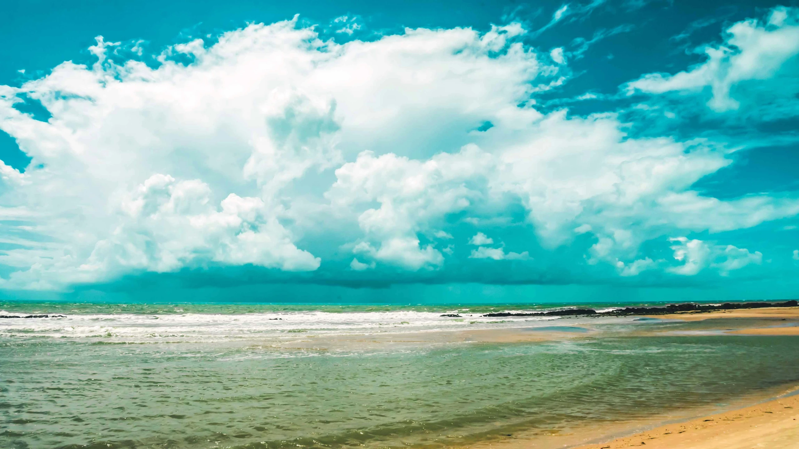 a group of people riding their surfboards on the ocean