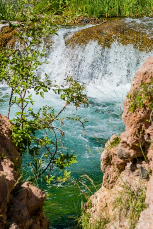 a waterfall with water and a bunch of rocks