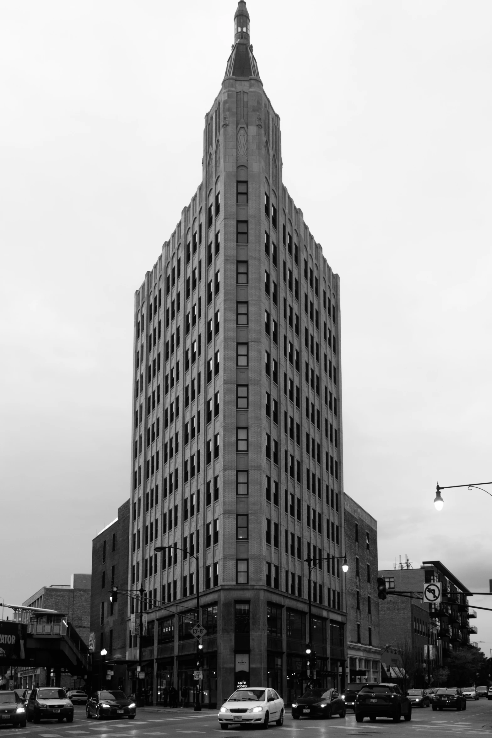 a very tall building sitting across from a very few cars