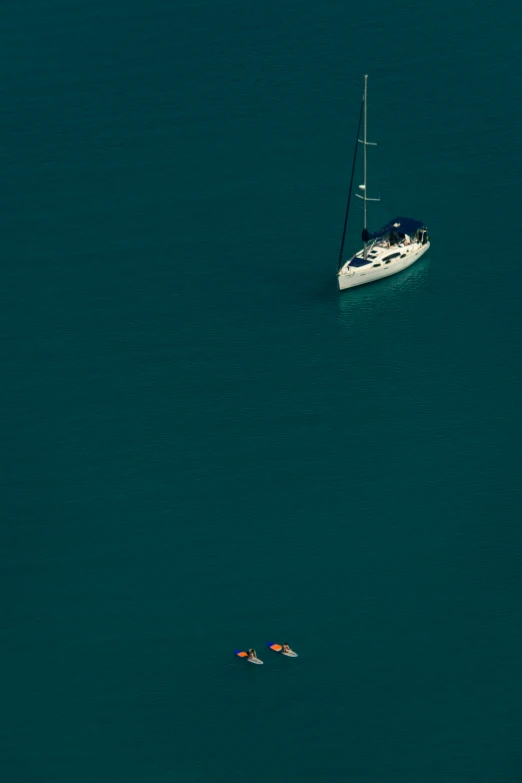 two small boats float through the blue ocean