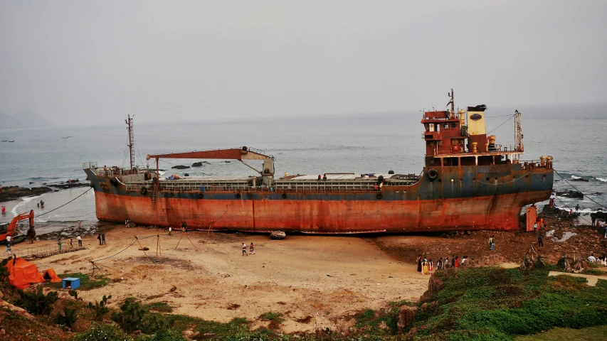 the boat is laying on land and missing sail