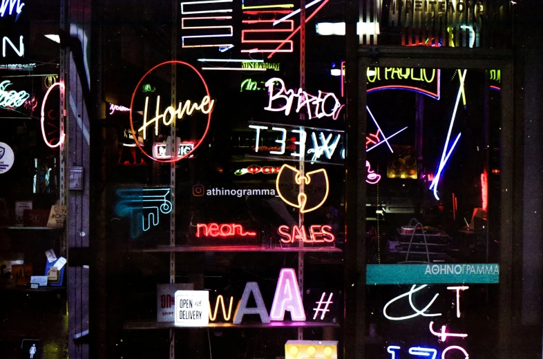 neon signs and the words happy new year in many languages