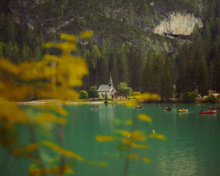 a lake with boats floating in the middle of it