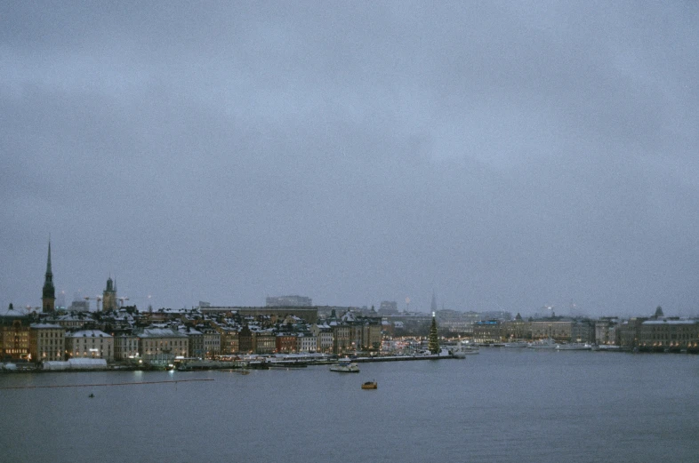 a cloudy day with a boat sailing on the river