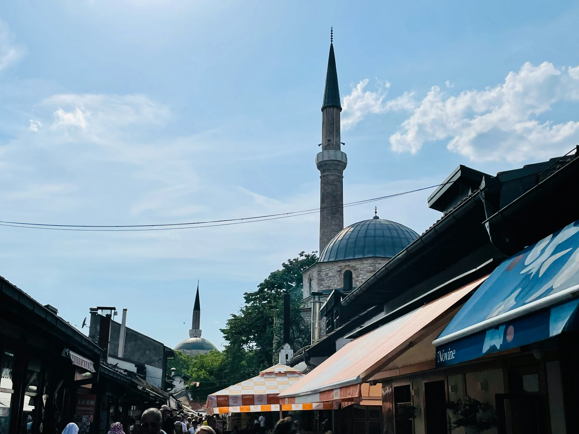 a street view of an old building and tall spire