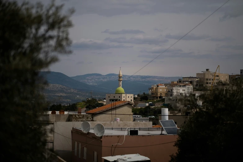 a roof top with lots of buildings and a yellow tower