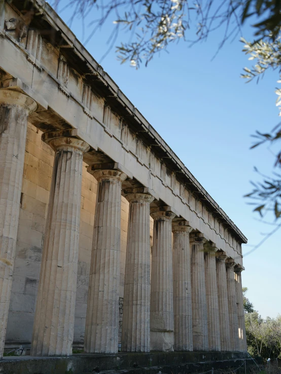 some old pillars are lined up against the blue sky