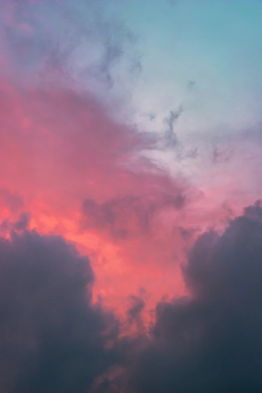 a plane is flying in the sky near clouds