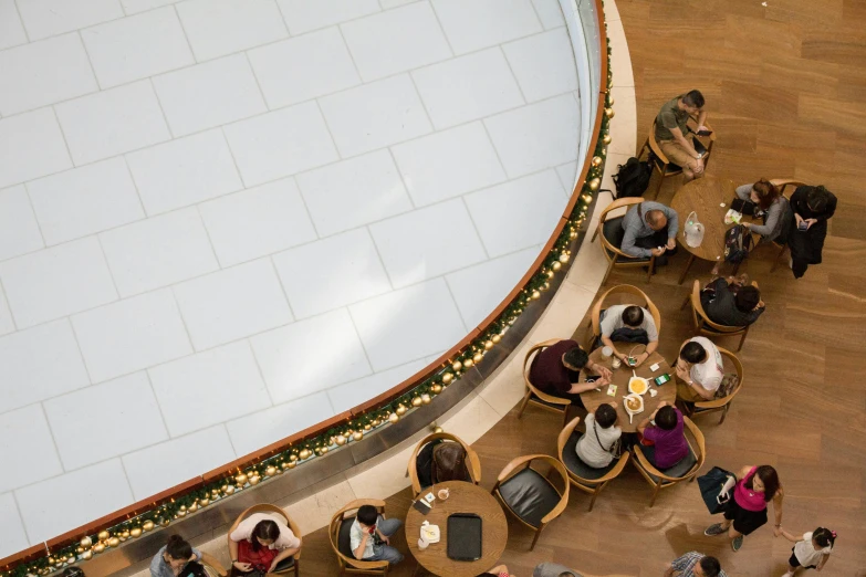 two people are standing near a round table