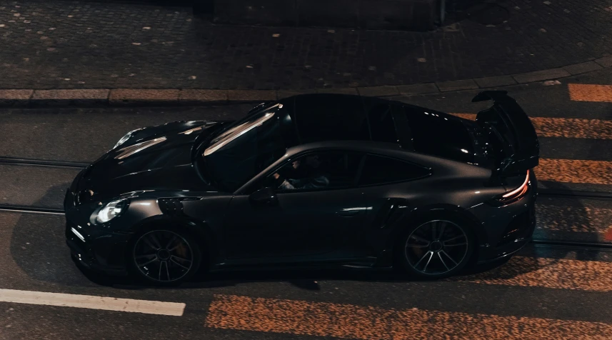 an aerial view of a car parked at a street corner