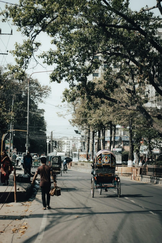 a city street with pedestrians, cars and people in it