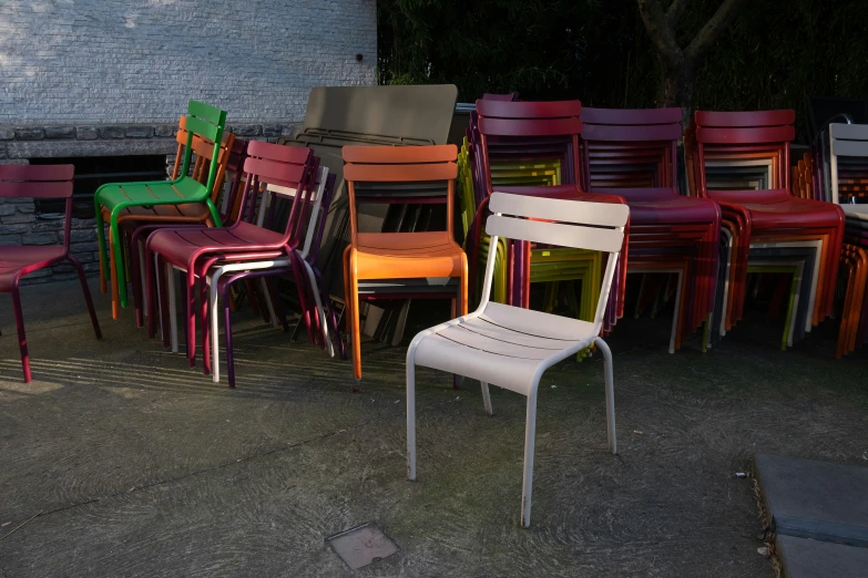 many different colored chairs are lined up next to each other