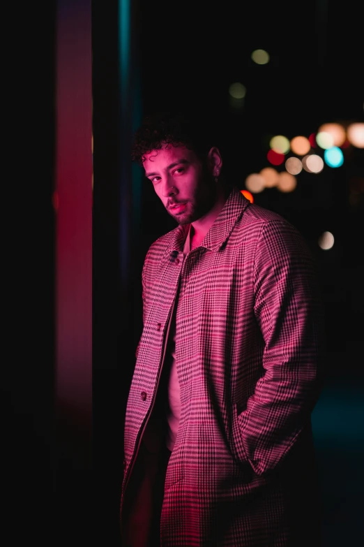 a man in a red and black shirt looking at the camera