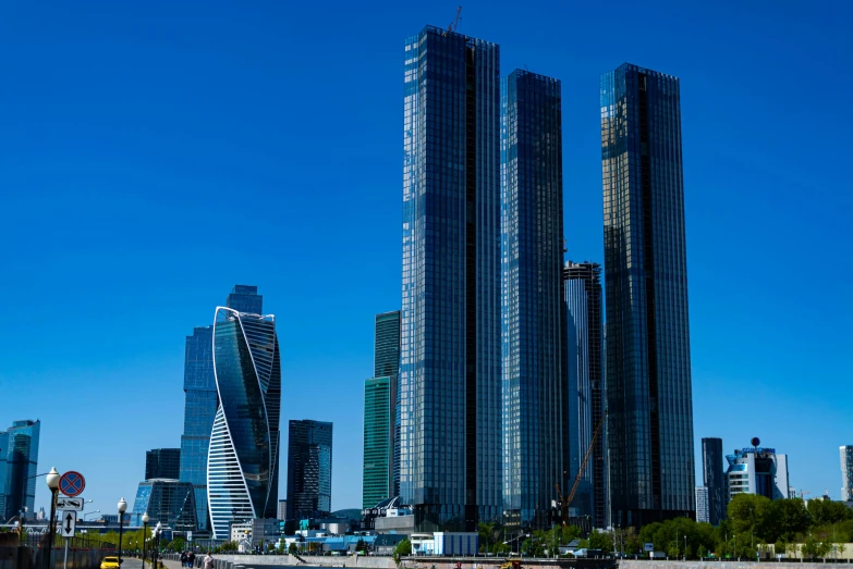 a city skyline with skyscrs near the river