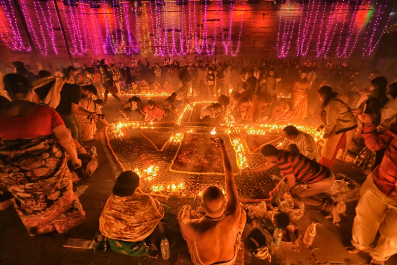 a group of people gathered around a lit up square