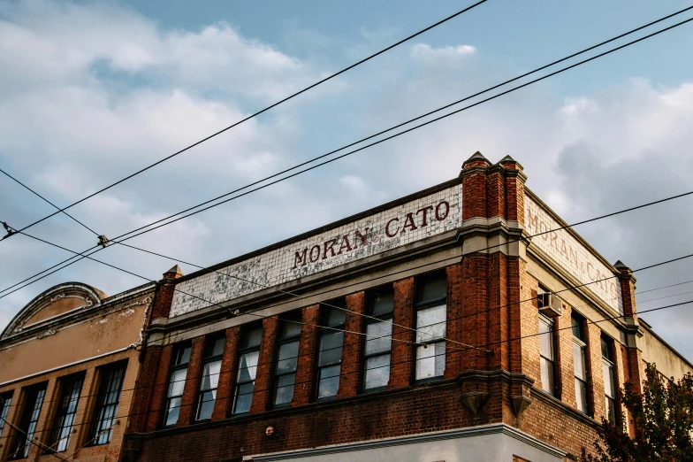 an old, brick building with power lines above it