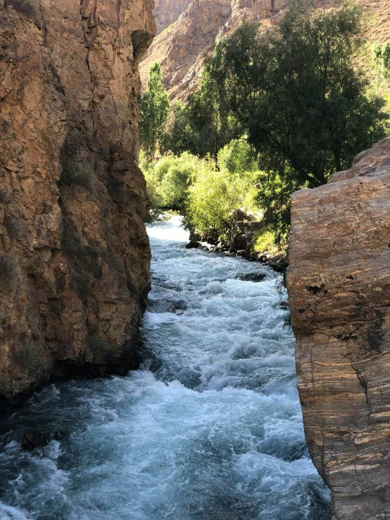 a rock face in the middle of a river