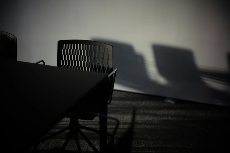 the shadow from two chairs on a table