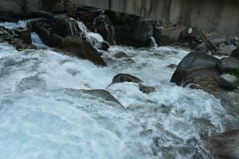 a bridge is shown with rapids in front