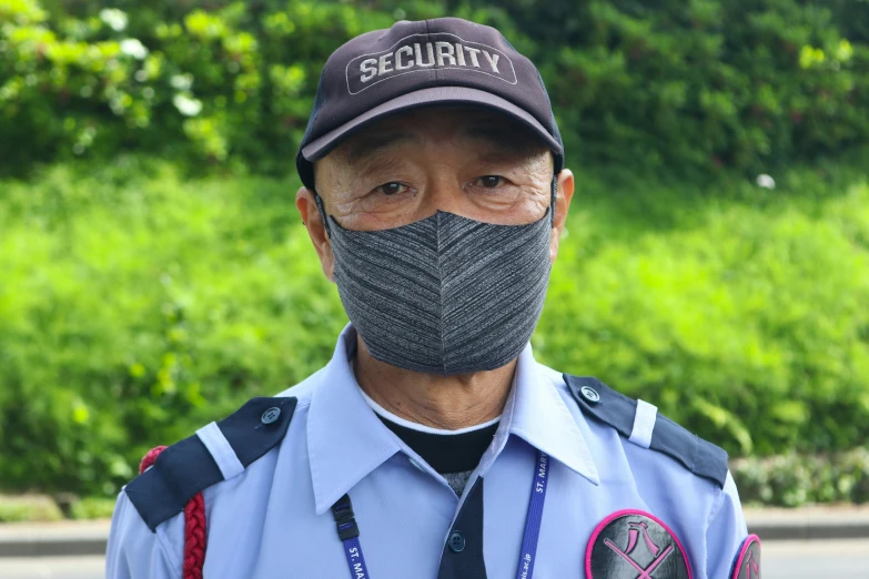 a security man with a long gray beard wearing a hat and badge