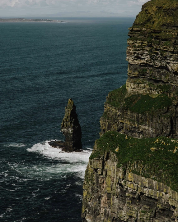 two cliffs on the ocean side with one of them cliff edge