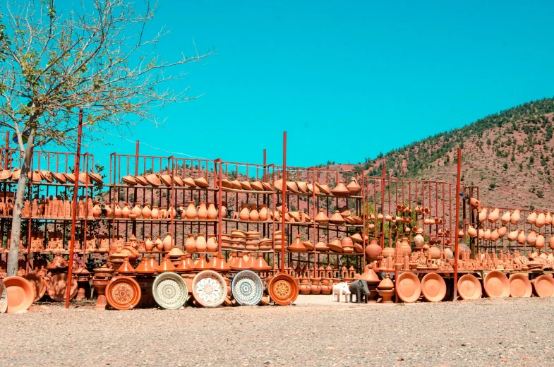 there is a large stack of pots sitting in the desert