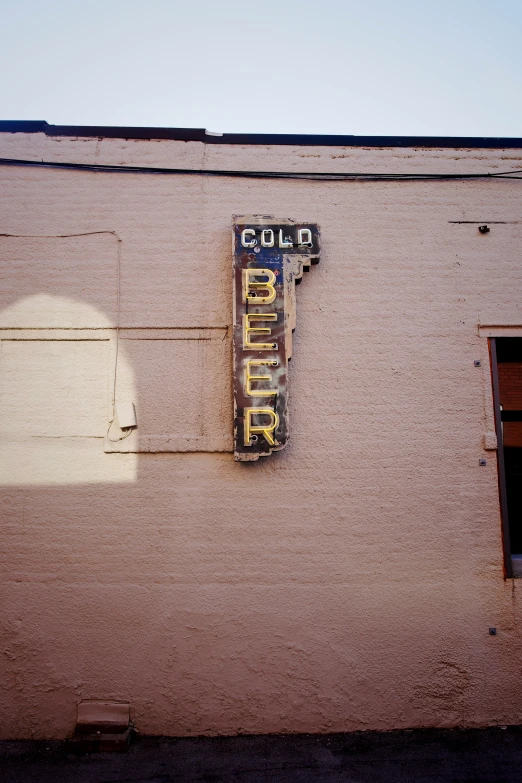 an old neon sign advertises the location for a business