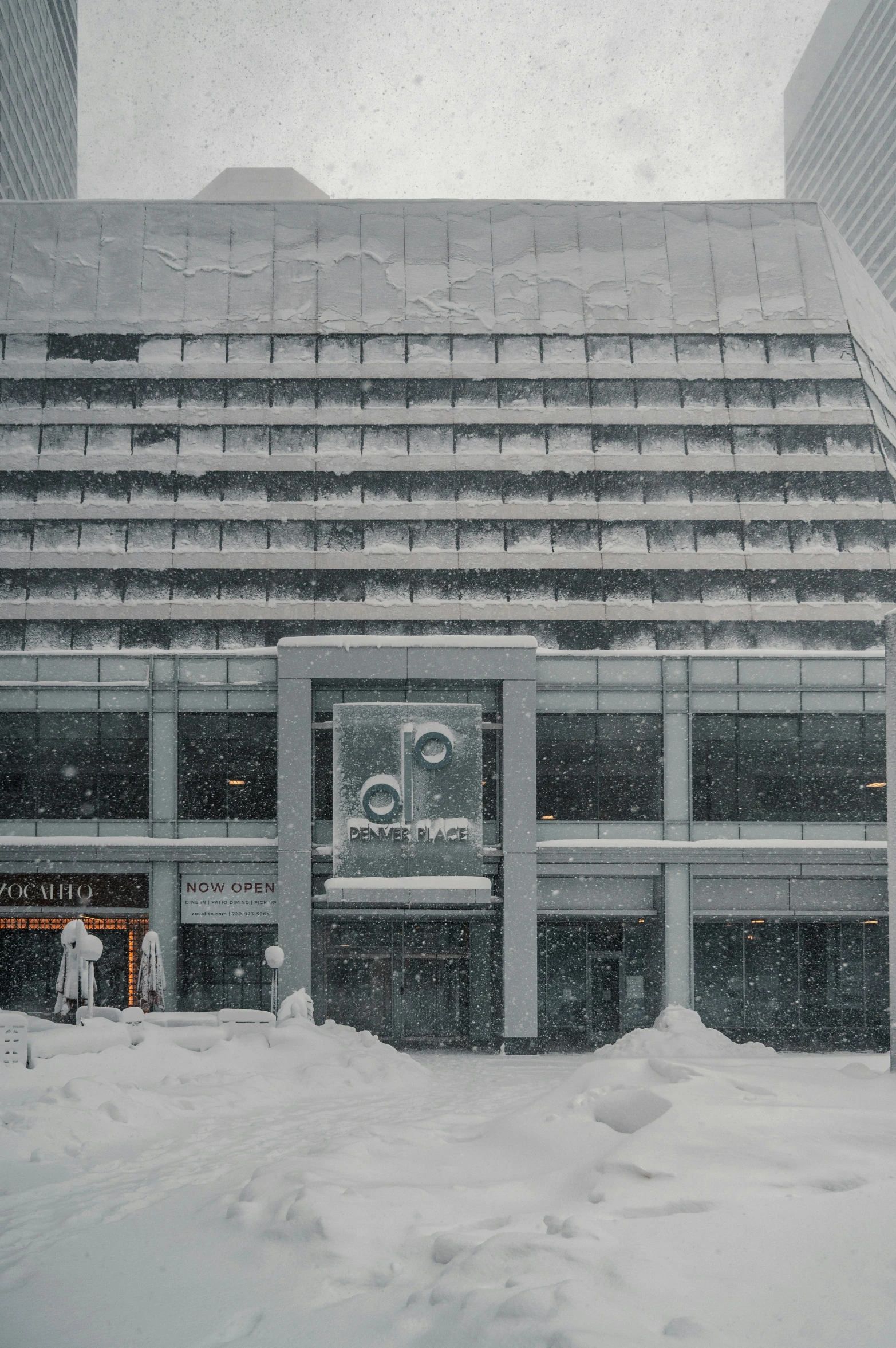 some people in the snow near a building