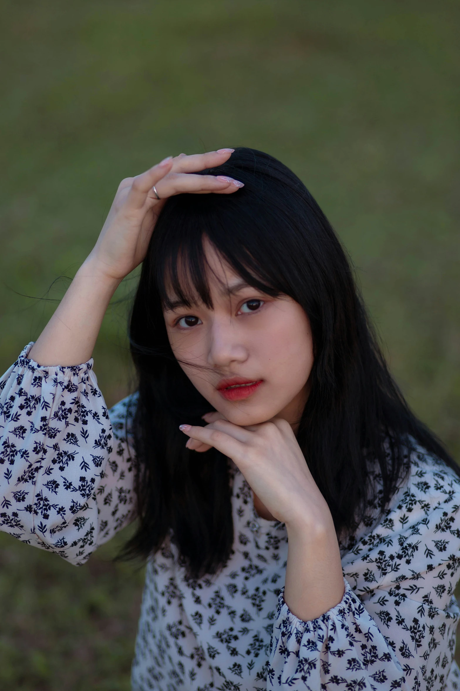 a woman posing for a pograph in a park