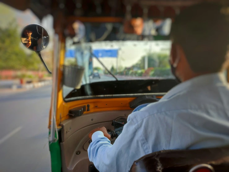 the back end of a bus that is driving down a street