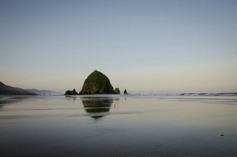 an object sits in the shallow water on a beach