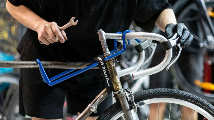 a man is checking the handle bars on his bicycle