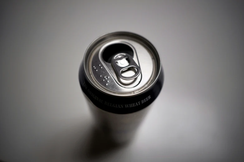 a can of beer is shown on a white table