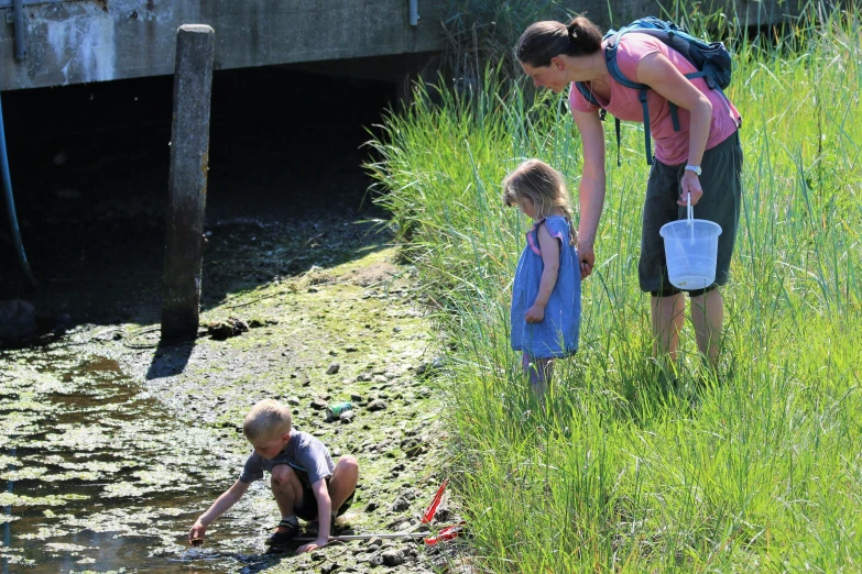 a woman is helping her young child reach for soing