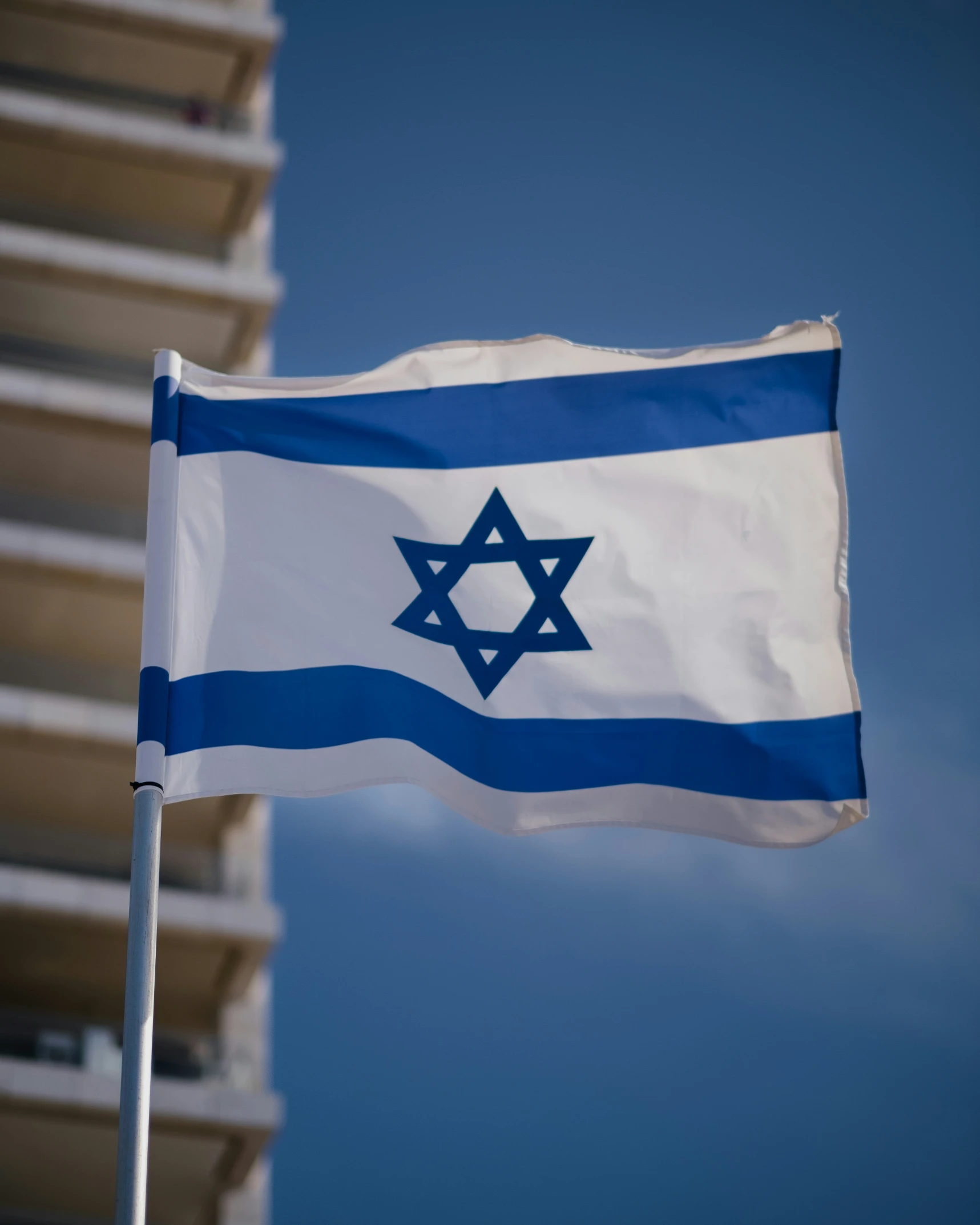 the israeli flag is on a pole