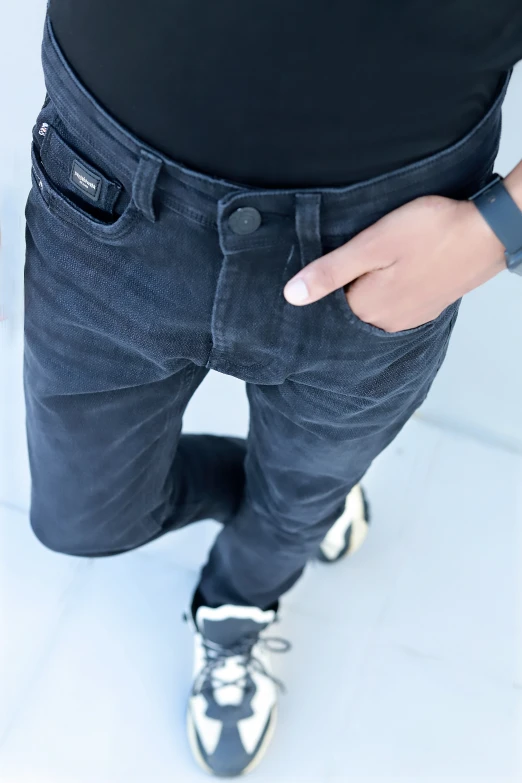 a man that is wearing some black pants and a watch