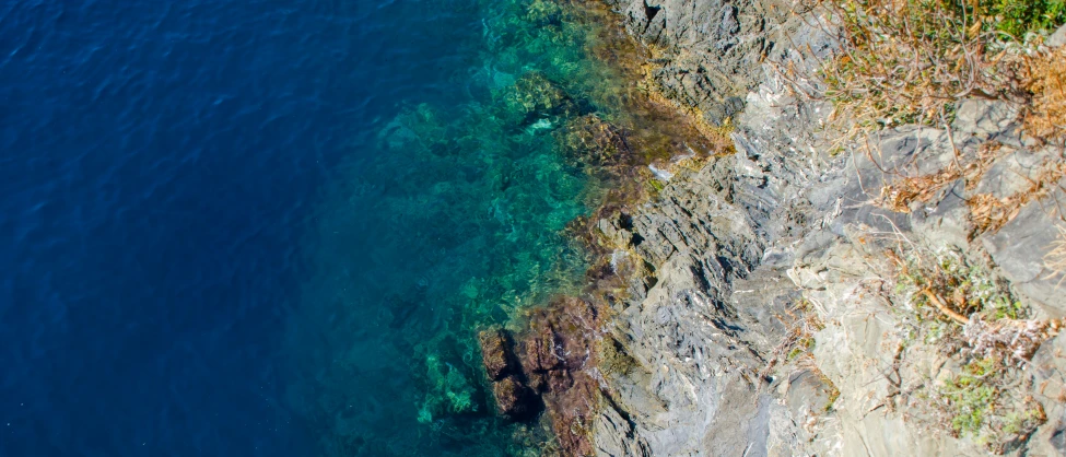 aerial view of the water and rocks at a beach