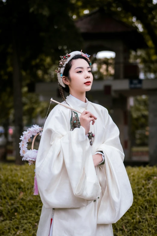 an oriental woman in white clothing and holding a basket