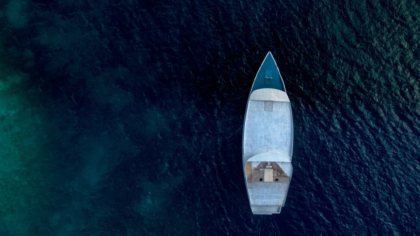 a large boat in the ocean next to a dock