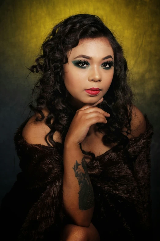 a young lady with red lips and tattoos sitting on the floor